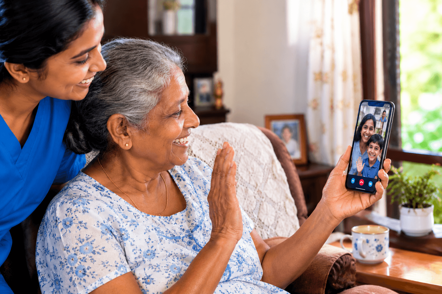 An elderly woman video calling her overseas family with a CareBridge Lanka care coordinator beside her